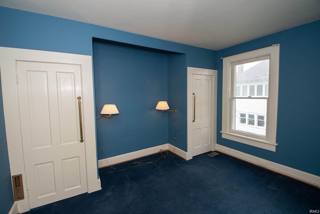 113 W N Shore Dr, South Bend, IN 46617 - unfurnished room featuring baseboards, dark carpet, and visible vents