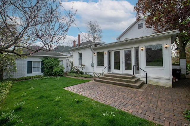 113 W N Shore Dr, South Bend, IN 46617 - back of property with entry steps, a chimney, a patio area, french doors, and a yard