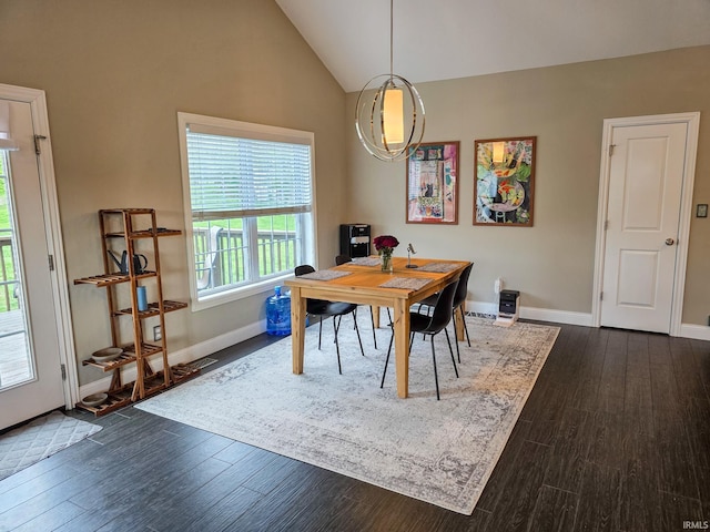 dining space featuring baseboards, dark wood-style floors, and high vaulted ceiling