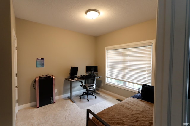 carpeted home office featuring baseboards