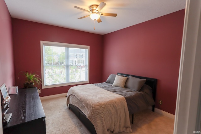 bedroom featuring baseboards, ceiling fan, and carpet