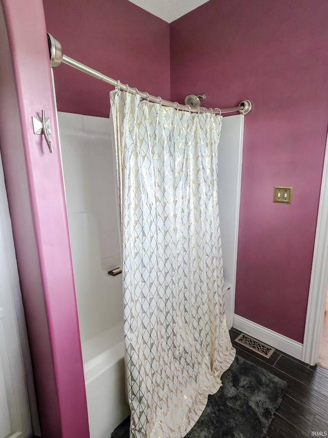 bathroom featuring visible vents, baseboards, and shower / bath combination with curtain