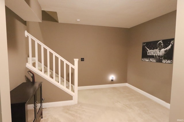 stairs with baseboards and carpet