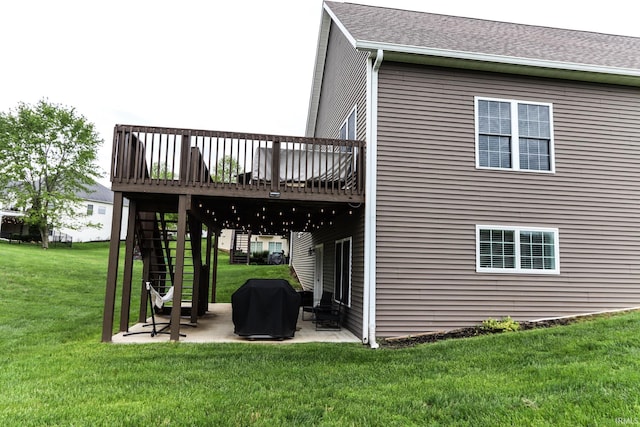 rear view of property with a patio, a lawn, stairway, and a deck