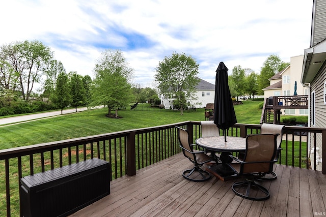 wooden deck featuring a yard and outdoor dining space