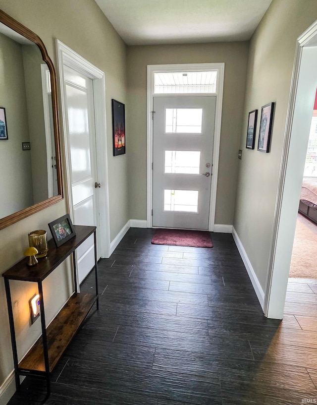 entryway with baseboards and dark wood-type flooring