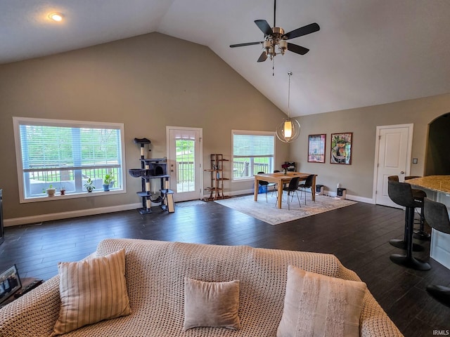 living area featuring ceiling fan, hardwood / wood-style flooring, and high vaulted ceiling