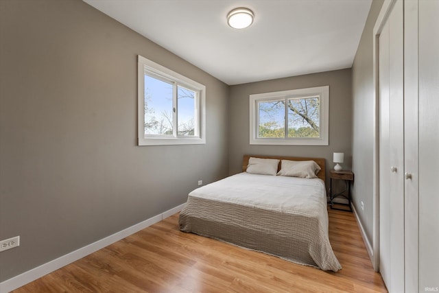 15860 Cook Lake Trl, Plymouth, IN 46563 - bedroom featuring baseboards, light wood finished floors, and a closet