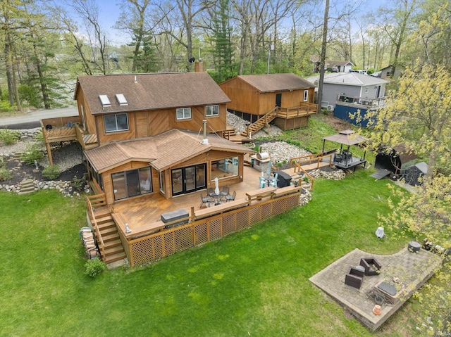 15860 Cook Lake Trl, Plymouth, IN 46563 - back of property featuring a chimney, a deck, a yard, a shingled roof, and stairs