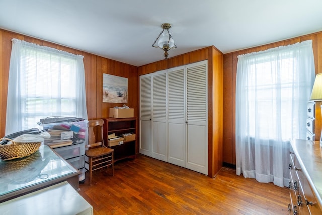 home office featuring wooden walls and wood finished floors