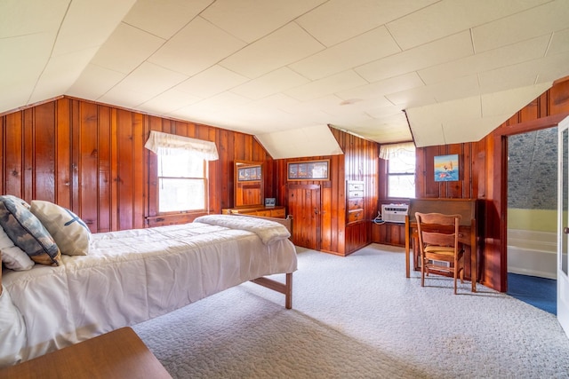 bedroom with wood walls, lofted ceiling, and multiple windows