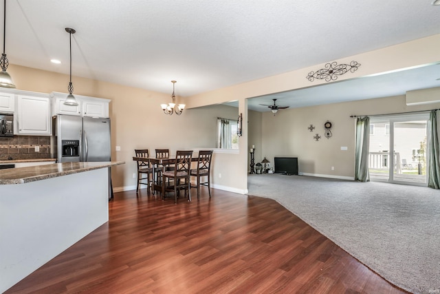 interior space with stainless steel fridge with ice dispenser, dark wood-style flooring, baseboards, white cabinets, and tasteful backsplash