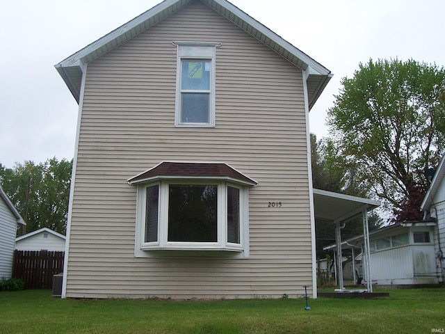 exterior space featuring a lawn and fence