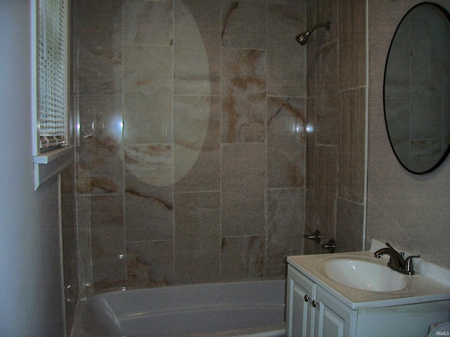 bathroom featuring vanity and  shower combination