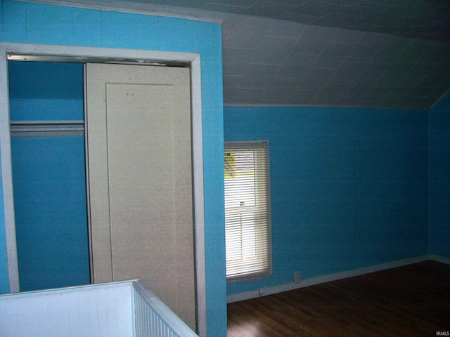 unfurnished bedroom with baseboards, a closet, and wood finished floors