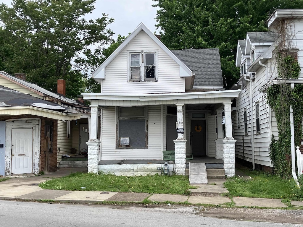 view of front of property featuring roof with shingles and covered porch