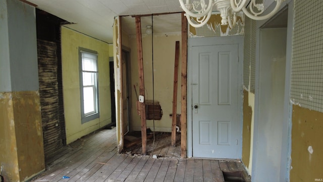 interior space featuring hardwood / wood-style flooring and a chandelier