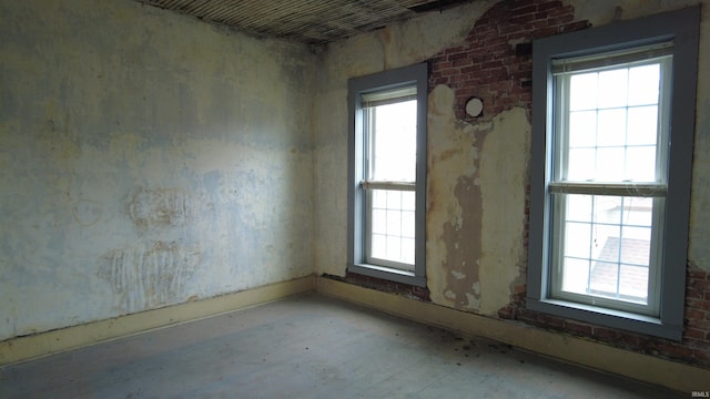 spare room with a healthy amount of sunlight and baseboards