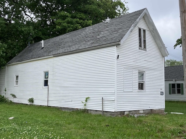 view of property exterior with a lawn