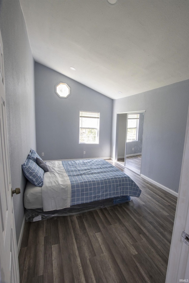 bedroom with baseboards and wood finished floors