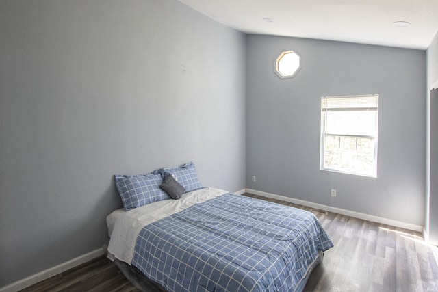 bedroom featuring baseboards and wood finished floors
