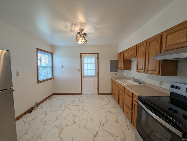 kitchen featuring marble finish floor, under cabinet range hood, electric panel, a sink, and appliances with stainless steel finishes