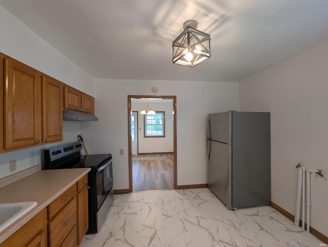 kitchen featuring appliances with stainless steel finishes, brown cabinets, a sink, marble finish floor, and under cabinet range hood