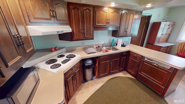 kitchen with light countertops, white electric cooktop, a peninsula, and under cabinet range hood