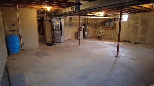 below grade area with heating unit and electric water heater