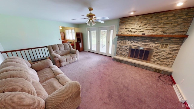 carpeted living area featuring french doors, a ceiling fan, visible vents, and a fireplace