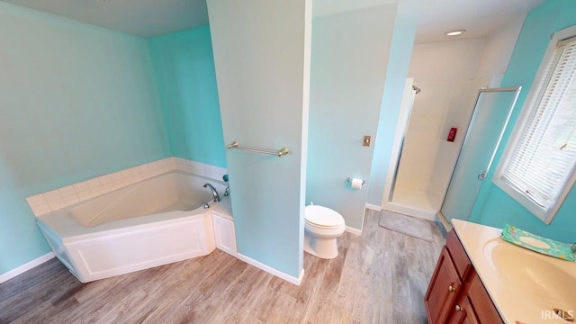full bath with a bath, a stall shower, toilet, and wood finished floors
