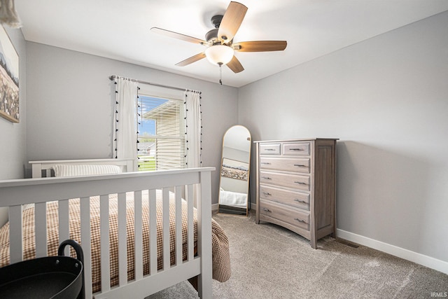 bedroom with a ceiling fan, baseboards, and light carpet