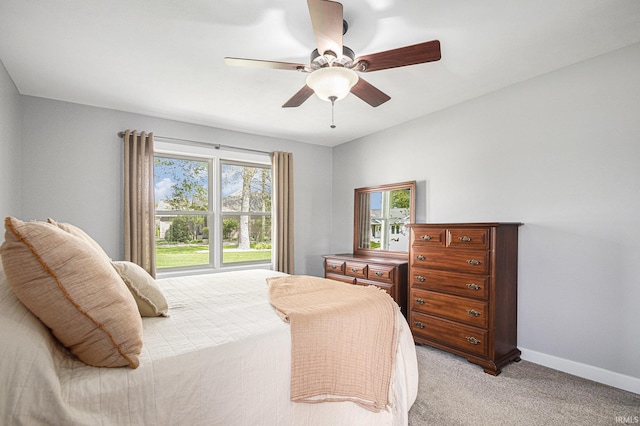 bedroom featuring a ceiling fan, baseboards, and light carpet