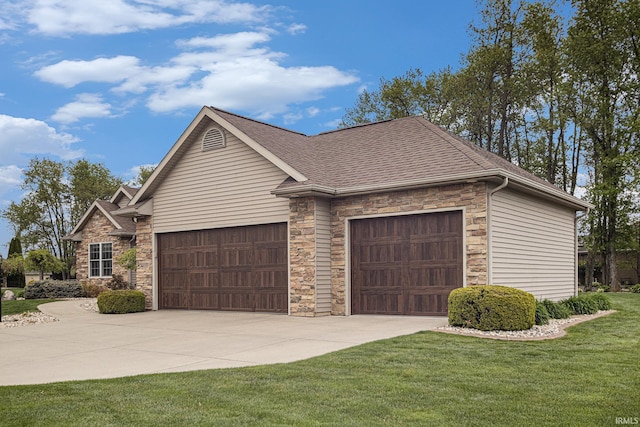 view of front of house featuring a garage, concrete driveway, a front lawn, and stone siding