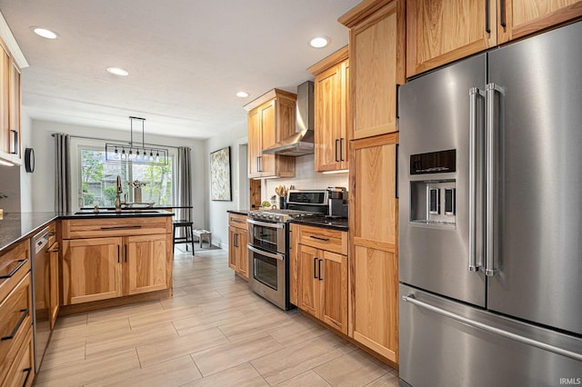 kitchen featuring decorative backsplash, wall chimney range hood, recessed lighting, a sink, and stainless steel appliances