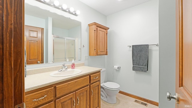 full bathroom featuring visible vents, vanity, toilet, tile patterned floors, and a shower stall