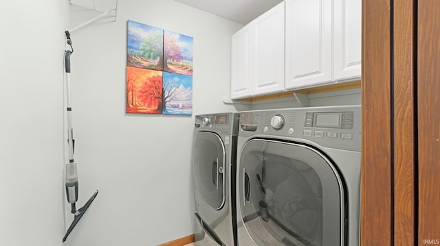 laundry room with baseboards, cabinet space, and washing machine and clothes dryer