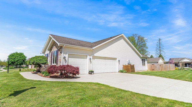 view of side of home with driveway, a lawn, a garage, fence, and a shingled roof