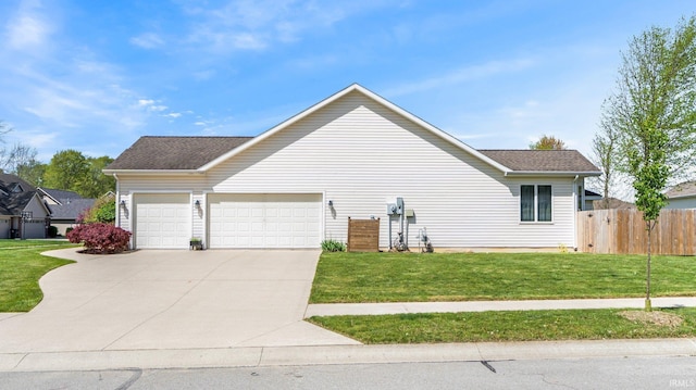view of property exterior featuring a garage, fence, roof with shingles, concrete driveway, and a yard