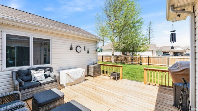 wooden terrace with a fenced backyard and a lawn