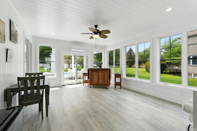 sunroom / solarium with a ceiling fan and wood finished floors