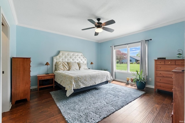 bedroom with dark wood-style flooring, crown molding, baseboards, and ceiling fan