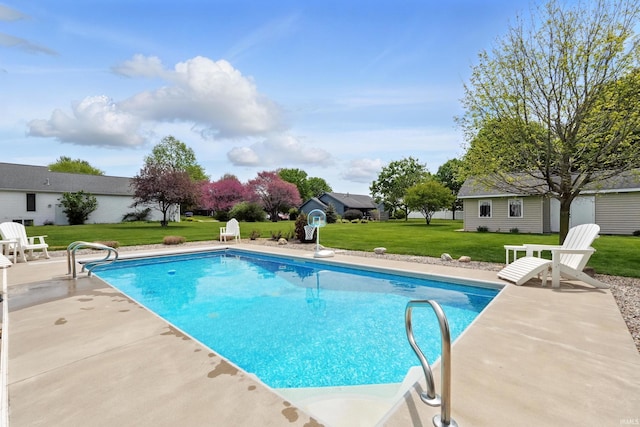 outdoor pool featuring a yard and a patio area