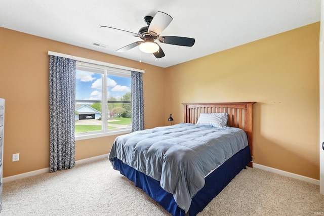 carpeted bedroom with baseboards and ceiling fan