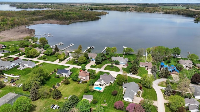 aerial view of property and surrounding area with a nearby body of water and nearby suburban area