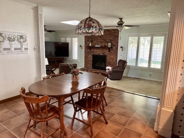 dining area with a fireplace, ceiling fan, and plenty of natural light