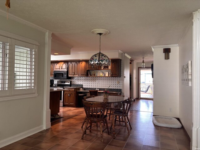 dining space with crown molding, a textured ceiling, and baseboards