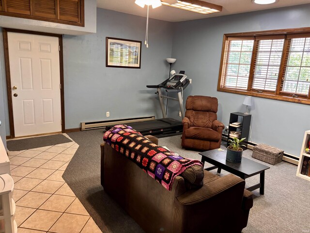 living area with light colored carpet, light tile patterned floors, ceiling fan, and baseboard heating