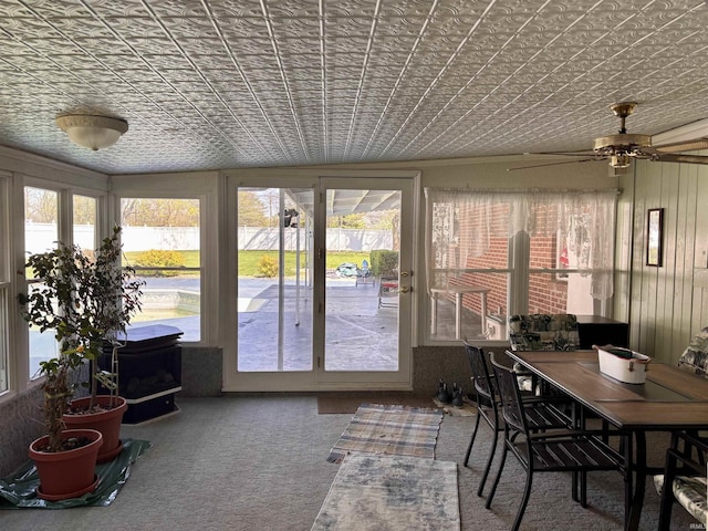 sunroom / solarium with carpet and an ornate ceiling