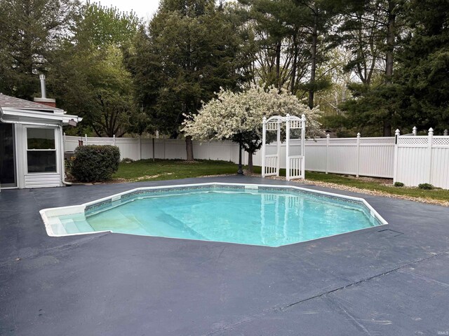 view of swimming pool with a patio area, a fenced in pool, and a fenced backyard